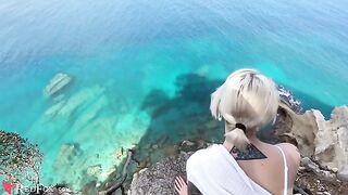 A cute young girl passionately sucks dick on the ocean shore