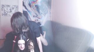 A couple enjoys intimate moments on their couch while listening to music