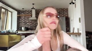 A pretty woman with glasses gets a cumshot on her face