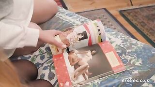 Two girls are having fun looking at the Kama Sutra before getting naked