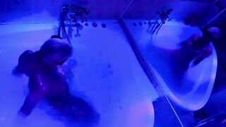 The pretty woman has a great fun in the bathroom with toys