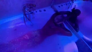 The pretty woman has a great fun in the bathroom with toys