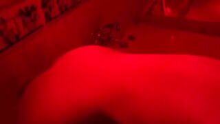 The pretty woman has a great fun in the bathroom with toys