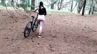 A beautiful girl took a bike ride and met a friend in the forest