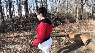 A woman with a big ass is wearing only yoga pants outdoors
