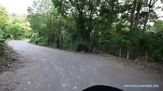 A cute girl is having her first ride on a motorbike with a stranger