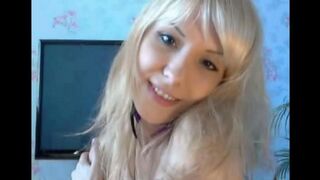Blonde caresses her pussy with fingers in a solo act