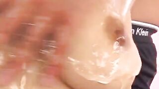 Hot Japanese chick rubs her boobies with oil and fingerbangs
