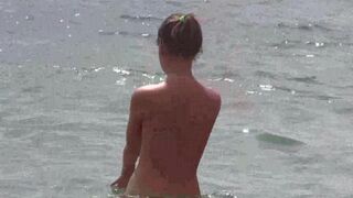 Nudists enjoy each other's company on the beach