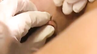 A hot brunette plays with her new clit piercing using a dildo