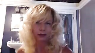 A golden-haired beauty aged over 50 has sex with a toothbrush in the bathroom