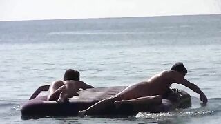 A naked beauty basks in the sun on the sandy beach