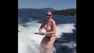 A sexy girl is water skiing without any clothes on her body