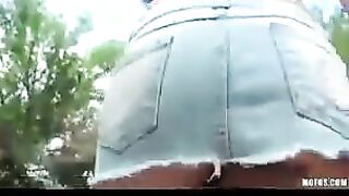 A hot brunette woman masturbates in the street, surrounded by busy passers-by