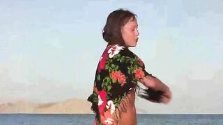 A member shows a girl the beach without clothes