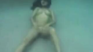 Underwater sex with a busty brunette, enjoying herself in the ocean