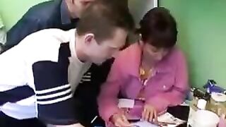 A Russian mother gets fucked by three guys in the kitchen