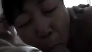 An old Chinese woman practices her blowjob skills with him