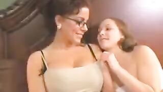 A sweet girl is having fun with her mother using a dildo
