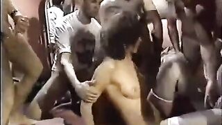 A girl in sexy stockings is having fun with a lot of guys