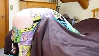A girl with a vest and a blindfold plays with her brother in a daring setup