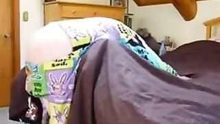 A girl with a vest and a blindfold plays with her brother in a daring setup