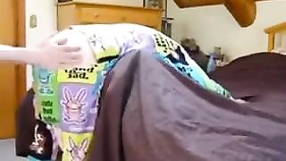 A girl with a vest and a blindfold plays with her brother in a daring setup