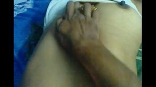 A husband massages the nipples of his wife in a steamy homemade scene