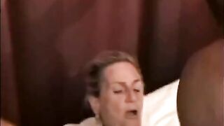 A mature woman is getting fucked by a black hung
