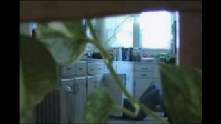 A married couple has fun while walking naked in their apartment