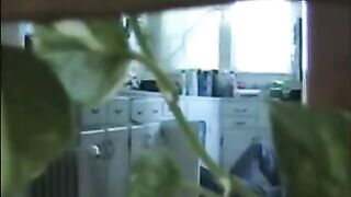 A married couple has fun while walking naked in their apartment