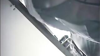 A hidden camera at the checkout shoots girls under their skirts in the store