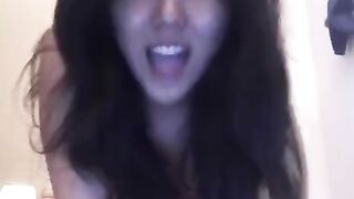 The cute Asian girl masturbates on her bed and reaches orgasm