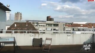 A hot brunette with big tits has sex on the roof in HD quality