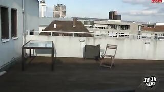 A hot brunette with big tits has sex on the roof in HD quality