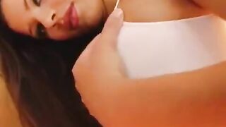 A woman plays with her large and wet vagina using a dildo