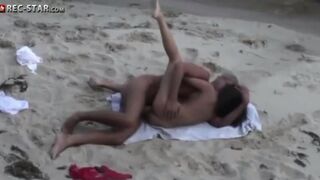 A couple has sex on the beach, not noticing the hidden camera