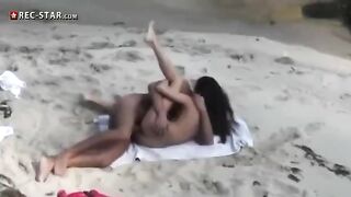 A couple has sex on the beach, not noticing the hidden camera