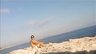 A naked girl basks in the sun’s rays on a sunny afternoon