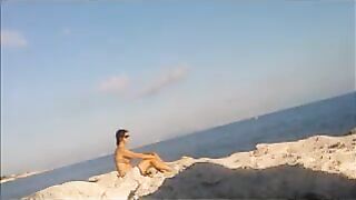 A naked girl basks in the sun’s rays on a sunny afternoon