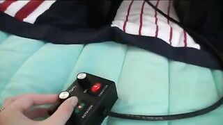 Three girls are having fun with each other using a vibrator