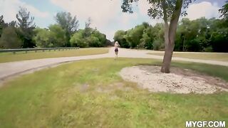 A girl is having fun with her boyfriend in the park outdoors
