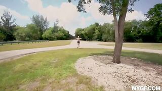 A girl is having fun with her boyfriend in the park outdoors