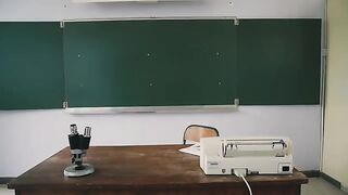The girl is enjoying herself in the classroom, following teacher's instructions