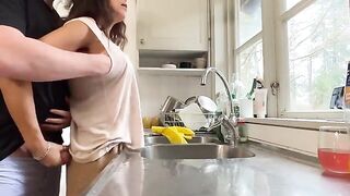 A mature woman with big tits is having sex right in the kitchen