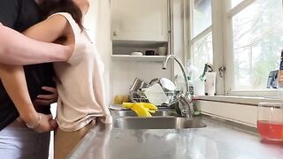 A mature woman with big tits is having sex right in the kitchen